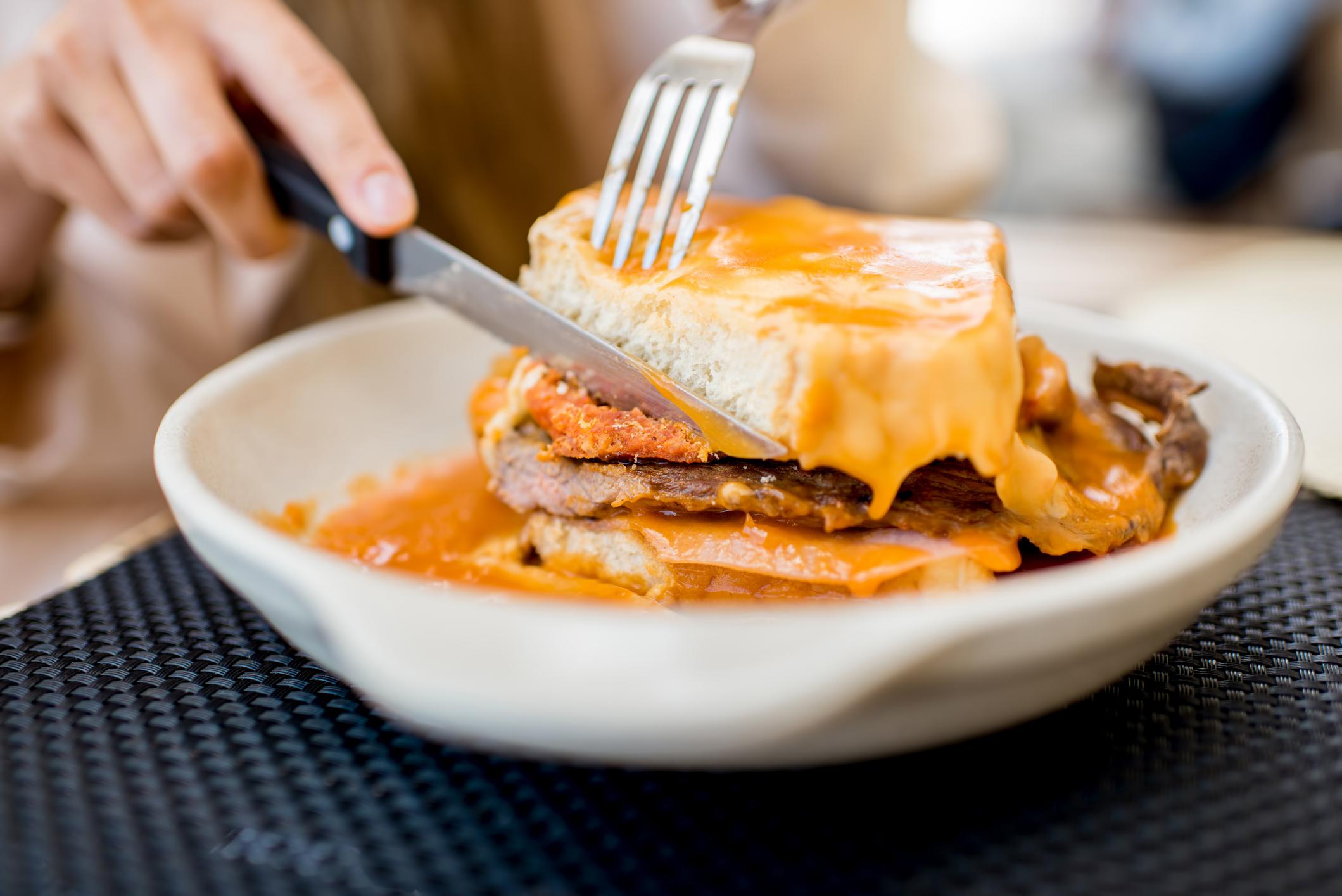 Eating a traditional Portuguese Francesinha sandwich in Porto. Photo: Getty