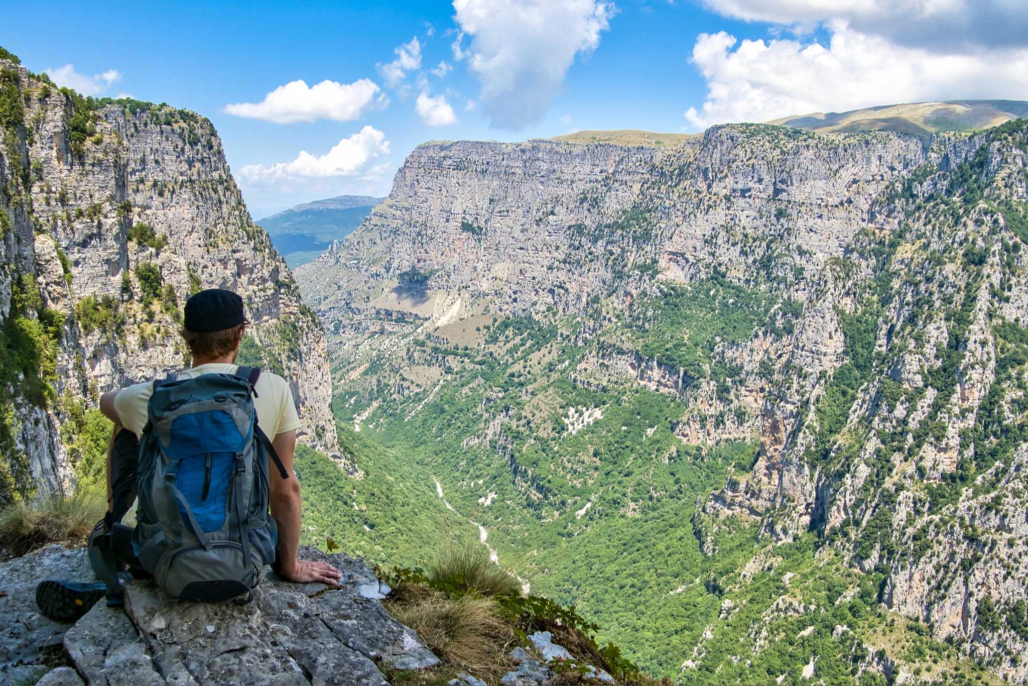 A hiker looking out over Vikos Gorge, Greece.