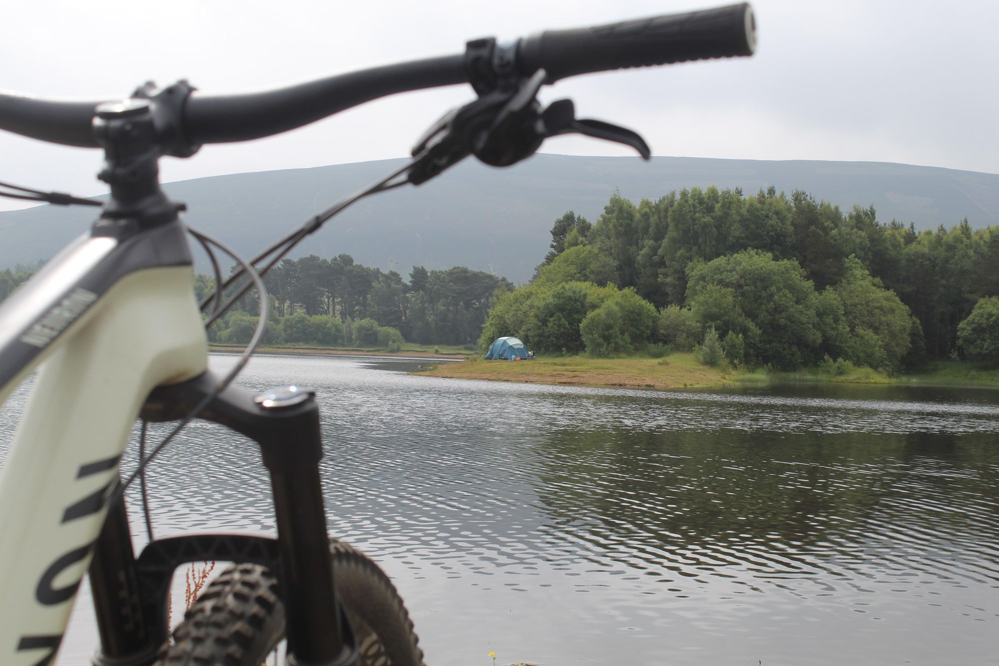 A tent pitched on the edge of a reservoir in the Pentland Hills. Photo: Stuart Kenny