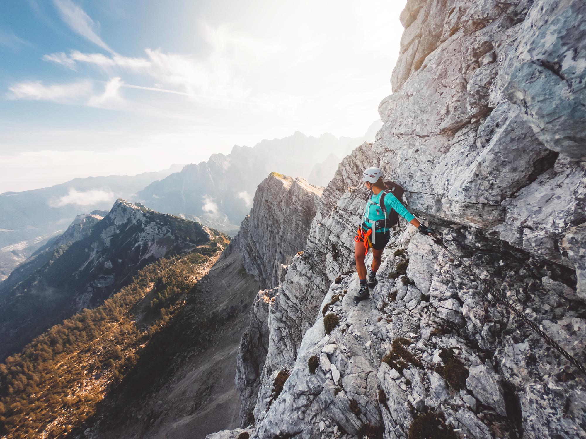 A woman on a via ferrata in the Slovenian Alps.