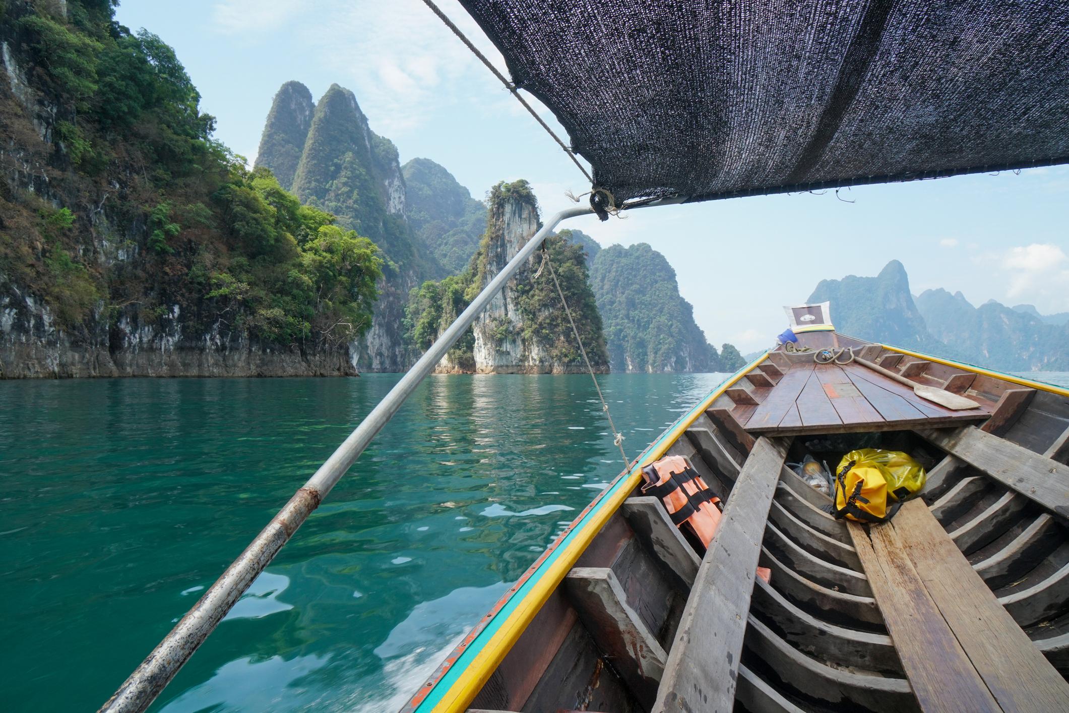 A longtail boat travelling across Cheow Lan. Photo: Getty.